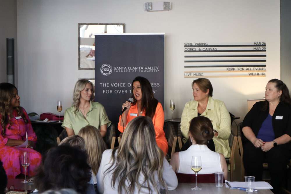 Jenny Ketchepaw (orange suit), a featured panelist, speaks to attendees at the Santa Clarita Valley Chamber of Commerce's "InfluenceHER: Boardroom Ready" event at Kindred Spirits Wine Bar in Valencia, Calif., Tuesday, March 10, 2026. Kamryn Martell/The Signal