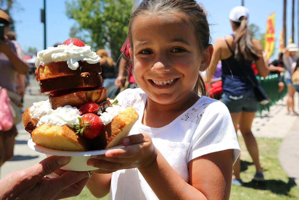 Enjoy the iconic Strawberry Shortcake Experience at the California Strawberry Festival, May 16-17 at the Ventura County Fairgrounds. This mouth-watering treat is a must-try for anyone who loves the taste of summer. Made with tender, flaky cake, whipped cream, and heaps of plump, ripe strawberries. Photo California Strawberry Festival.