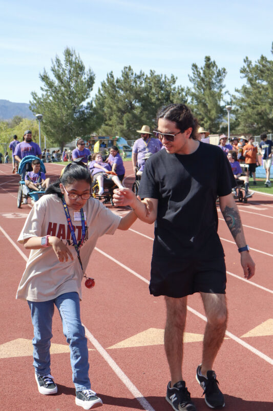 Sabrina Diamos (left), a Golden Valley adult transition program student, races with Cesar Guillen's help (right), a Golden Valley teacher aid, at the 14th annual Hart Games at Valencia High School in Valencia, Calif., Monday, March 16, 2026. Kamryn Martell/The Signal