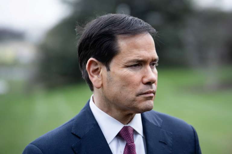 Secretary of State Marco Rubio listens as President Donald Trump speaks to reporters before departing the White House on March 20, 2026. Photo by Madalina Kilroy.
