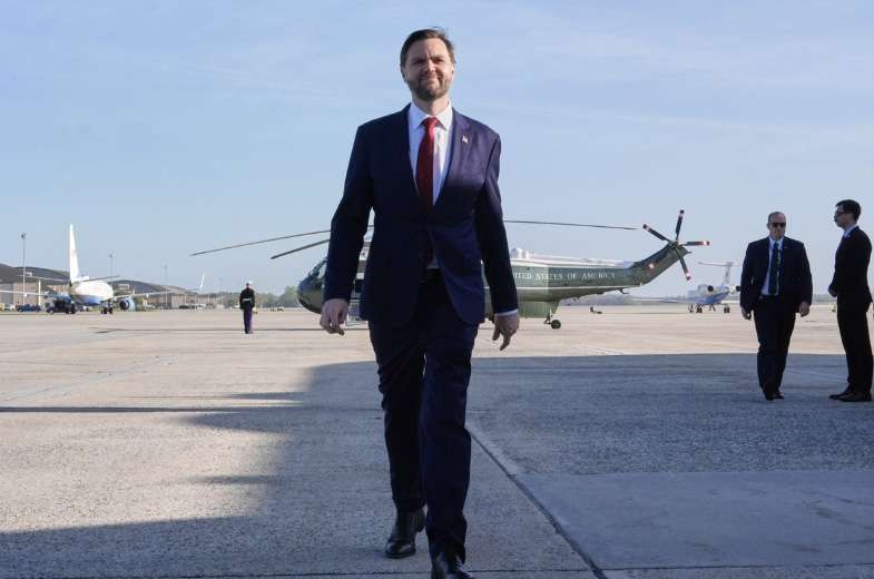 Vice President JD Vance walks to speak to reporters before boarding Air Force Two at Joint Base Andrews, Maryland, on April 10, 2026, as he departs for Pakistan for talks on Iran. Pool photo by Jacquelyn Martin/AFP via Getty Images