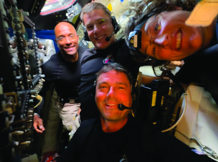 Midway through their lunar observation period, the Artemis II crew members—(L-R) Victor Glover, Jeremy Hansen, Reid Wiseman, and Christina Koch—pause to turn the camera around for a selfie inside the Orion spacecraft on April 6, 2026. (Courtesy of NASA).