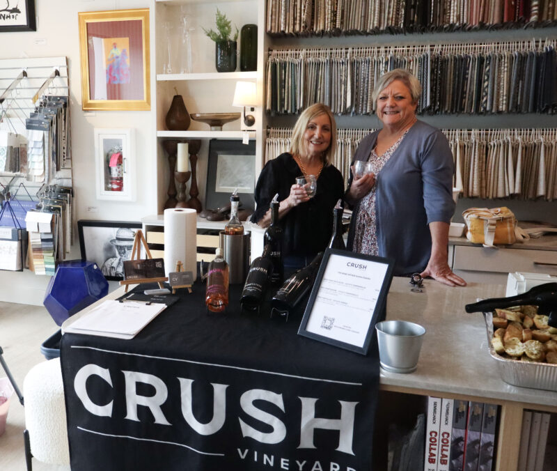 Denise Schramm (L) and Debrah Manahan (R) smile for a photo at their booth at the Soroptimist International of Greater Santa Clarita Valley's 17th annual "Wine Affair: Sip, Savor, Stroll" in Newhall, Calif., Sunday, April 12, 2026. Kamryn Martell/The Signal