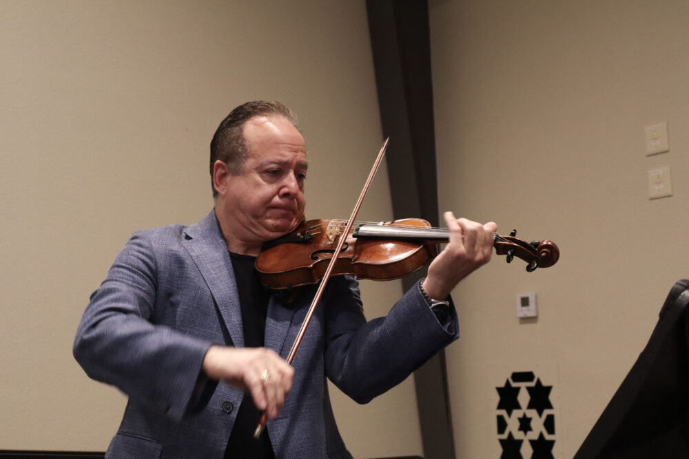 Jonathan Rubin plays some music on composer Shony Braun's violin at the "The Symphony of the Holocaust" screening at Congregation Beth Shalom in Santa Clarita, Calif., Sunday, April 12, 2026. Kamryn Martell/The Signal