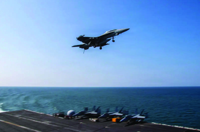 An F/A-18F Super Hornet, attached to Strike Fighter Squadron (VFA) 41, flies over the flight deck of Nimitz-class aircraft carrier USS Abraham Lincoln (CVN 72) in support of Operation Epic Fury on March 6, 2026. U.S. Navy via Getty Images