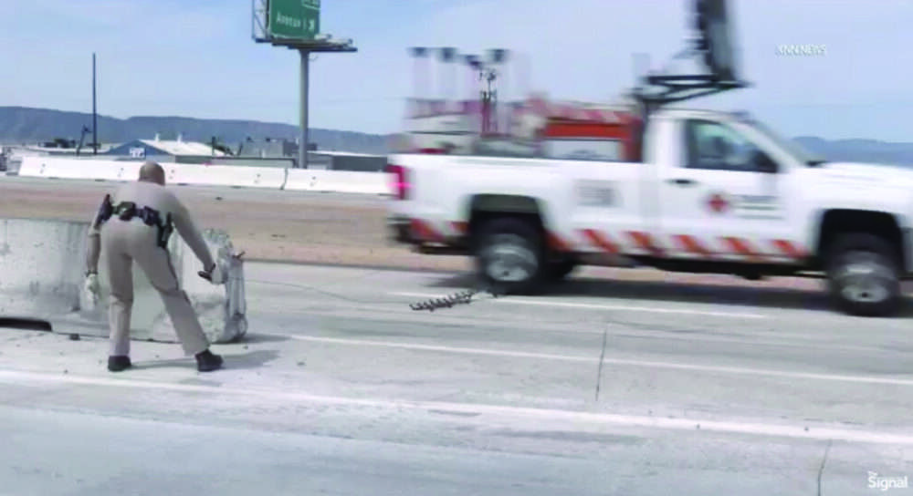 A California Highway Patrol officer successfully deploys a spike strip to disable a reportedly stolen work struck involved in a pursuit that started Thursday in Sylmar and passed through the Santa Clarita Valley before ending near Rosamond in the Antelope Valley. Screenshot from video by Eyad Alawi/KNN, for The Signal.