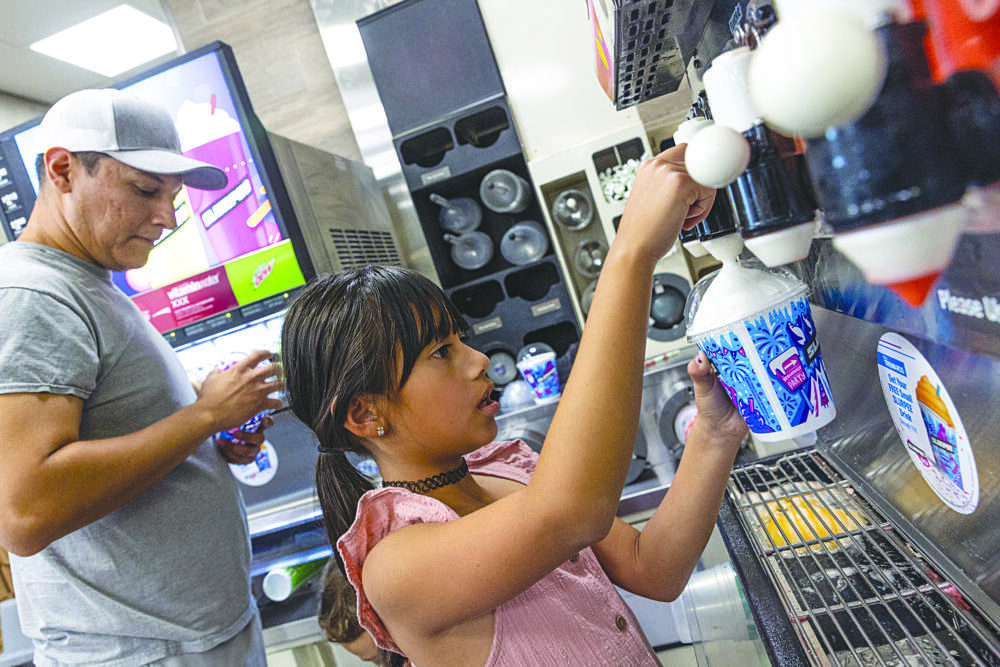 Adalyn Rodriguez, 7, fills her free Slurpee cup with the Piña Colada flavor for National 7-Eleven Day at the Valencia location on Newhall Ranch Road on Monday, July 11, 2022. Chris Torres/The Signal