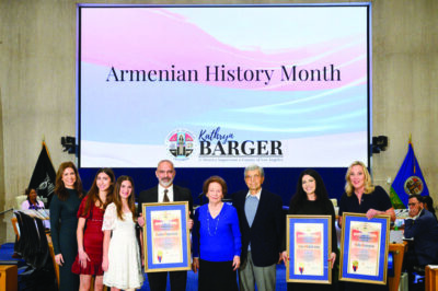 Supervisor Kathryn Barger presents commemorative scrolls to Armenian community honorees during a ceremony at the Los Angeles County Board of Supervisors meeting. Pictured from left: Jill Panossian, Leah and Samantha Panossian, Dr. Andre Panossian and his parents, ServiceTitan representative Alene Aroustamian, and Barger. Photo by Bryan Chan/L.A. County.