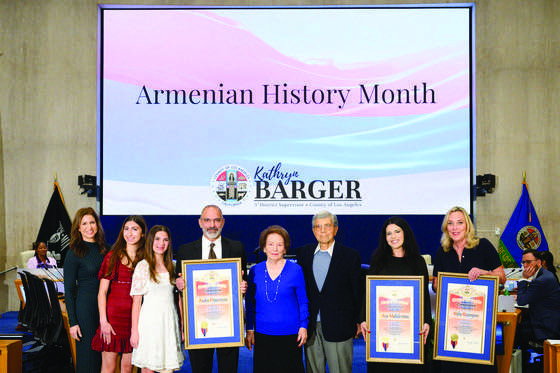 Supervisor Kathryn Barger presents commemorative scrolls to Armenian community honorees during a ceremony at the Los Angeles County Board of Supervisors meeting. Pictured from left: Jill Panossian, Leah and Samantha Panossian, Dr. Andre Panossian and his parents, ServiceTitan representative Alene Aroustamian, and Barger. Photo by Bryan Chan/L.A. County.