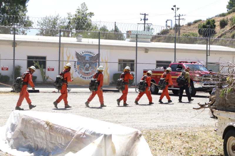 The inmates of graduating class 64 walk to the site for their drills at the Inmate Fire Training Program graduation ceremony at Pitchess Detention Center in Castaic, Calif., Wednesday, April 29, 2026. Kamryn Martell/The Signal