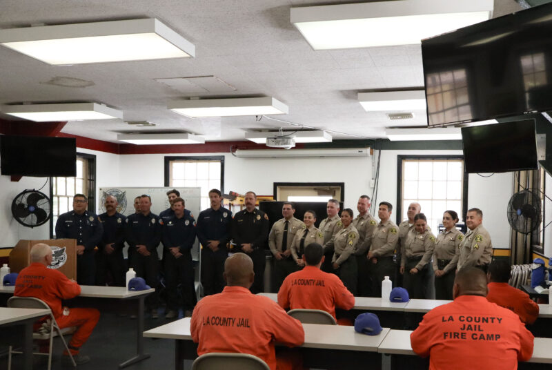 Los Angeles County Sheriff's Department officials and Inmate Fire Crew Training Camp officials smile for a photo at the Inmate Fire Training Program graduation ceremony at Pitchess Detention Center in Castaic, Calif., Wednesday, April 29, 2026. Kamryn Martell/The Signal