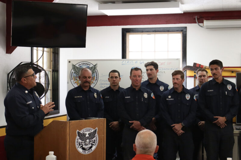 Capt. David Hernandez (far left) gives a speech to the crowd at the Inmate Fire Training Program graduation ceremony at Pitchess Detention Center in Castaic, Calif., Wednesday, April 29, 2026. Kamryn Martell/The Signal