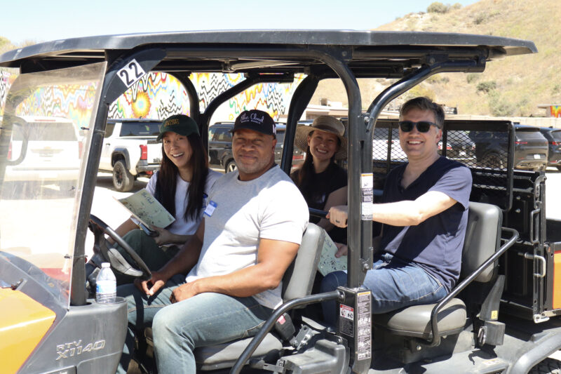 Attendees smile for a photo while driving a golf cart at Blue Cloud Movie Ranch in Santa Clarita, Calif., Monday, May 11, 2026. Kamryn Martell/The Signal