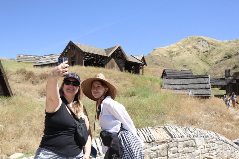 Alison Flierl and Tate Hanyok smile for a photo in front of the "Rebel Moon" movie sets at Blue Cloud Movie Ranch in Santa Clarita, Calif., Monday, May 11, 2026. Kamryn Martell/The Signal