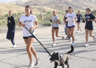 Gianna Matranga (L, white shirt), a senior at West Ranch High School, runs with Shyla, 1, a Husky mix, at the fourth annual West Ranch High "Run With Dogs" event at the Santa Clarita Valley Animal Care Center in Castaic, Calif., Sunday, May 17, 2026. Kamryn Martell/The Signal