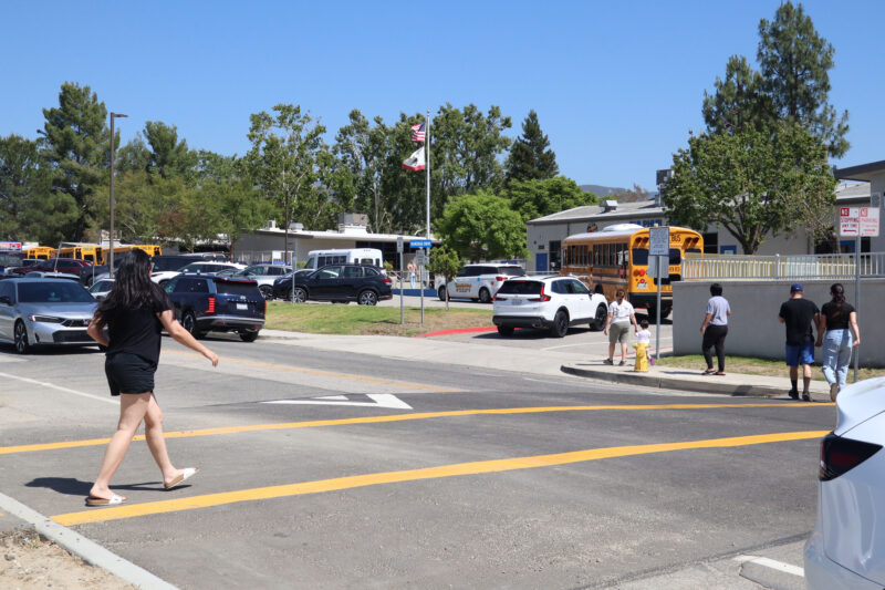 People cross the street using the crosswalk during school pickup at Sulphur Springs Community School in Canyon Country, Calif., Thursday, May 21, 2026. Kamryn Martell/The Signal