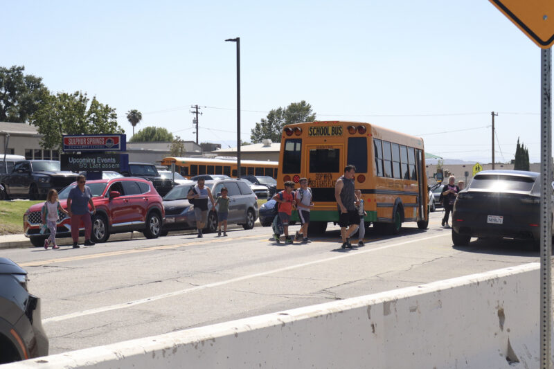 People jaywalk to get to their cars during school pickup at Sulphur Springs Community School in Canyon Country, Calif., Thursday, May 21, 2026. Kamryn Martell/The Signal