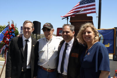 Local dignitaries and veterans smile for a photo at the Memorial Day Tribute at Eternal Valley Memorial Park and Mortuary in Newhall, Calif., Monday, May 25, 2026. Kamryn Martell/The Signal