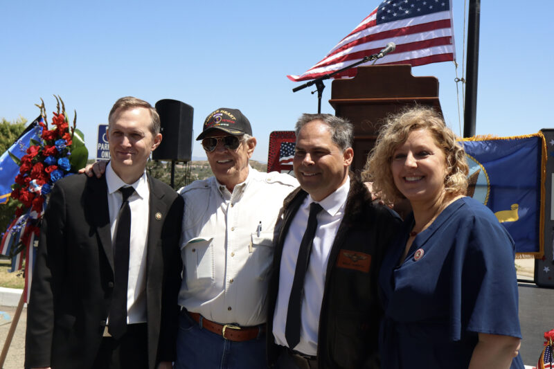 Local dignitaries and veterans smile for a photo at the Memorial Day Tribute at Eternal Valley Memorial Park and Mortuary in Newhall, Calif., Monday, May 25, 2026. Kamryn Martell/The Signal