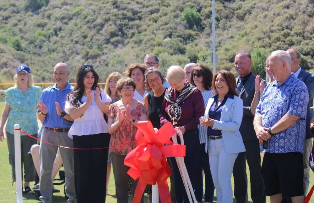 Local officials and the March family joined Mayor Laurene Weste on the baseball field for the Ribbon Cutting ceremony at David March Park on June 1, 2026. Sara McCarthy/ The Signal 