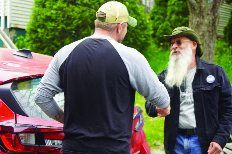 Graham Platner greets a supporter at a campaign event in Belfast, Maine, on June 6, 2026, just days ahead of the state's June 9 primary. Photo by Nathan Worcester.