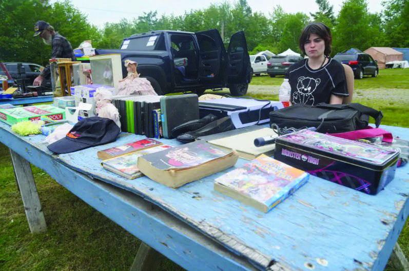 Kate Johnson sells items at a flea market in Searsport, Maine, on June 6, 2026. Photo by Nathan Worcester.