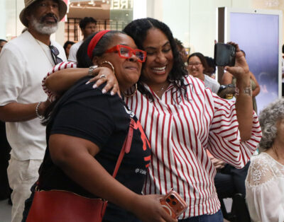 Keikei Dover (L) and Alicia Pigee hug at the "Juneteenth" gospel sunday celebration at Valencia Town Center in Valencia, Calif., Sunday, June 14, 2026. Kamryn Martell/The Signal