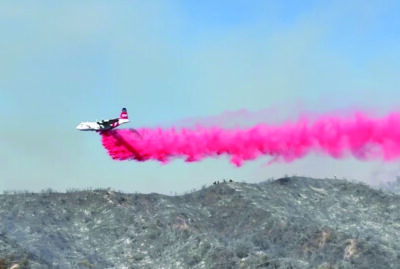 A fixed-wing aircraft makes a drop of Phos-Chek fire retardant on the Max Fire in Stevenson Ranch on Monday, June 15, 2026. Signal staff photo.