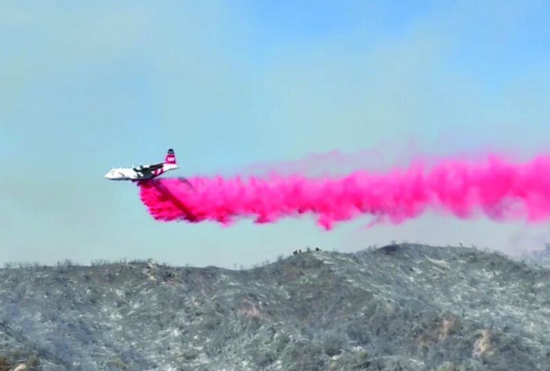 A fixed-wing aircraft makes a drop of Phos-Chek fire retardant on the Max Fire in Stevenson Ranch on Monday, June 15, 2026. Signal staff photo.