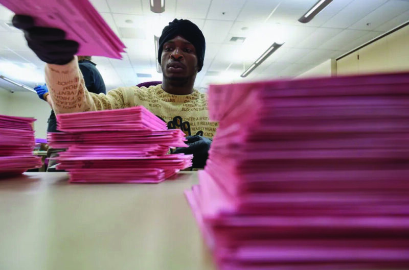 Ballot processor Elijah Thornabar organizes mail-in ballots at the Sacramento County Voter Registration and Elections office in Sacramento on June 2, 2026. Photo by Fred Greaves for CalMatters