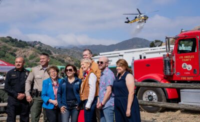 Local dignitiaries as an L.A. County Fire Department helicopter performs a water drop during the city’s Fire Safety Day ahead of the Fourth of July weekend on Saturday June 27, 2026. Katherine Quezada/The Signal