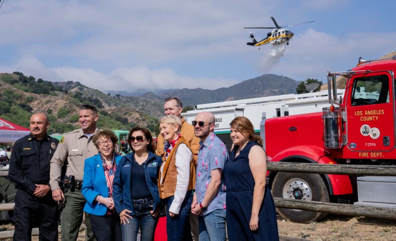 Local dignitiaries as an L.A. County Fire Department helicopter performs a water drop during the city’s Fire Safety Day ahead of the Fourth of July weekend on Saturday June 27, 2026. Katherine Quezada/The Signal