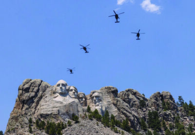 Black Hawk helicopters fly over Mount Rushmore National Memorial, outside of Rapid City, South Dakota, on July 2, 2026. Photo by John Fredricks.