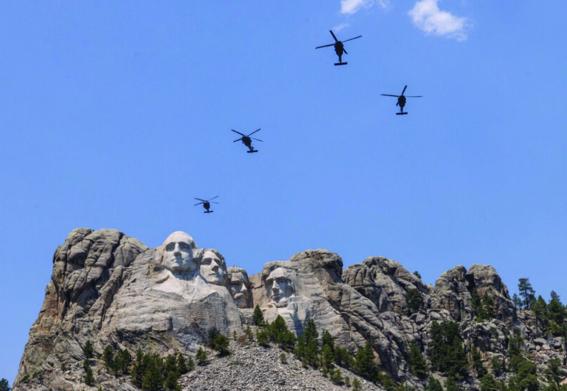 Black Hawk helicopters fly over Mount Rushmore National Memorial, outside of Rapid City, South Dakota, on July 2, 2026. Photo by John Fredricks.