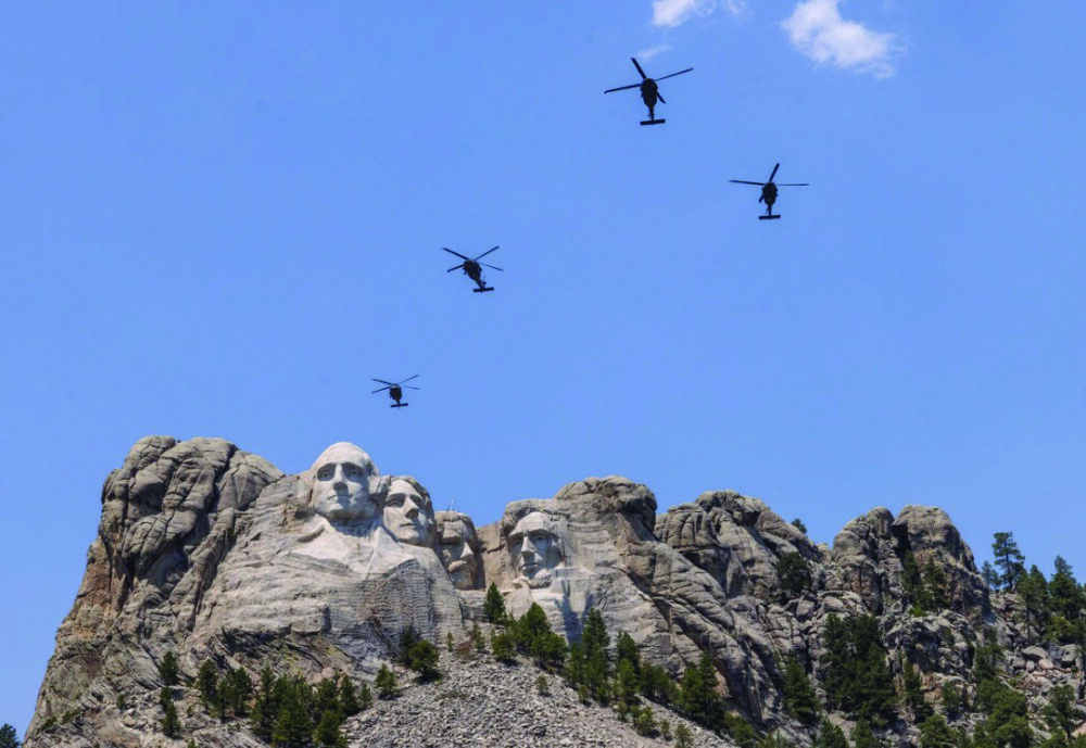 Black Hawk helicopters fly over Mount Rushmore National Memorial, outside of Rapid City, South Dakota, on July 2, 2026. Photo by John Fredricks.