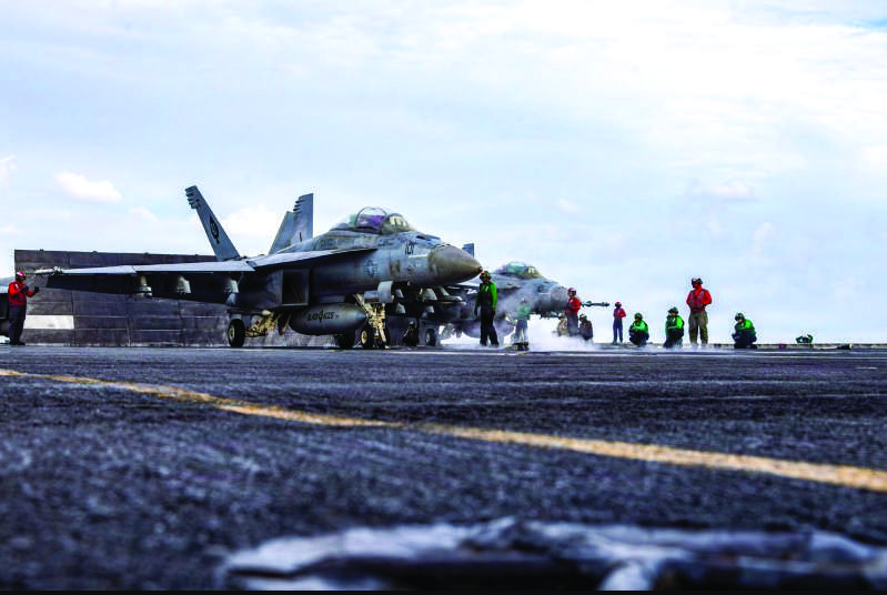 Two F/A-18E Super Hornets, attached to Strike Fighter Squadron (VFA) 41, prepare to launch from the flight deck of Nimitz-class aircraft carrier USS Abraham Lincoln during Operation Epic Fury, March 31, 2026. U.S. Navy photo
