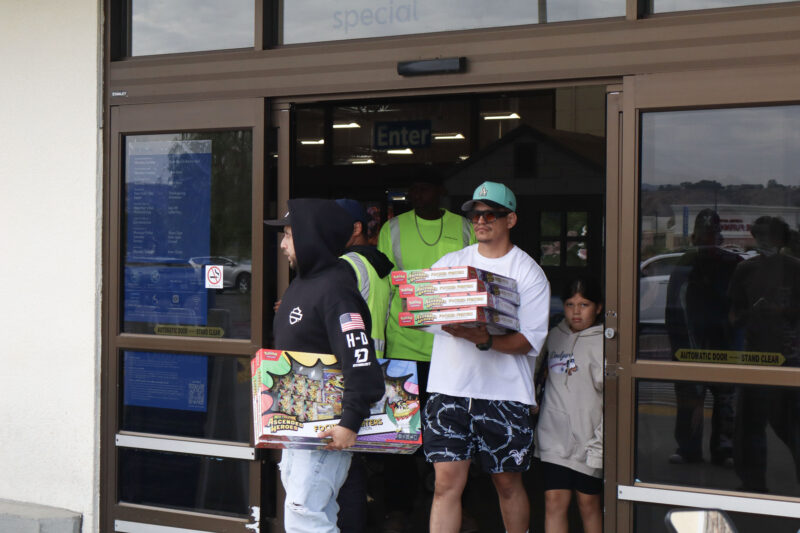 People walk out of Sam's Club with multiple Pokémon boxes in Canyon Country, Calif., Tuesday, June 21, 2026. Kamryn Martell/The Signal