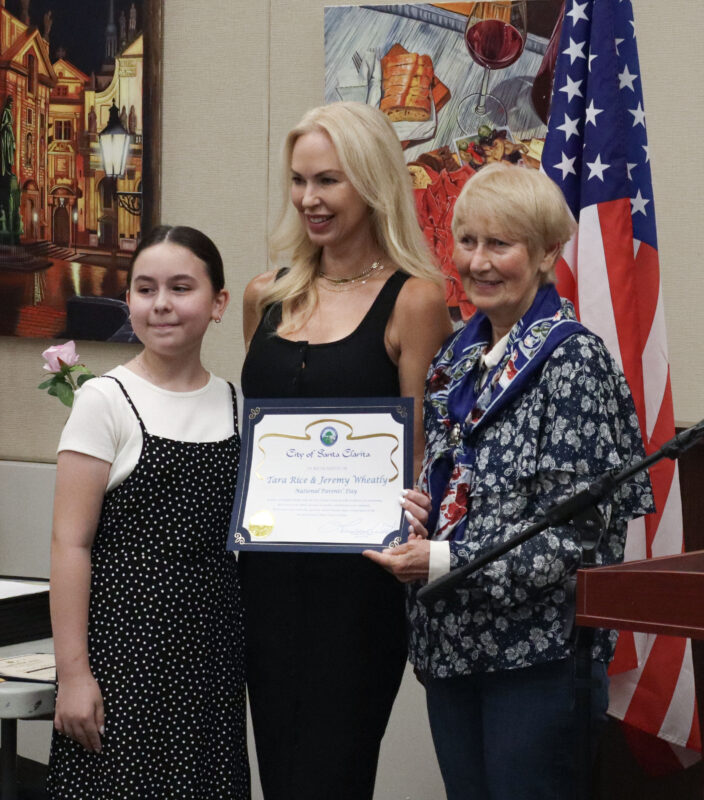 Tara Rice (C), receives her award with Charlie LeRoy (R), 11, and Laurene Weste, mayor of the city of Santa Clarita, pose at the inaugural National Parents Day awards ceremony at the Old Town Newhall Library in Newhall, Calif., Sunday, July 26, 2026. Kamryn Martell/The Signal