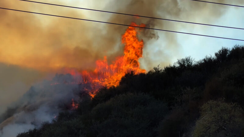 The Tasha Fire blazes through Sierra Highway and Neeham Ranch Parkway on Saturday evening. Signal Staff/The Signal