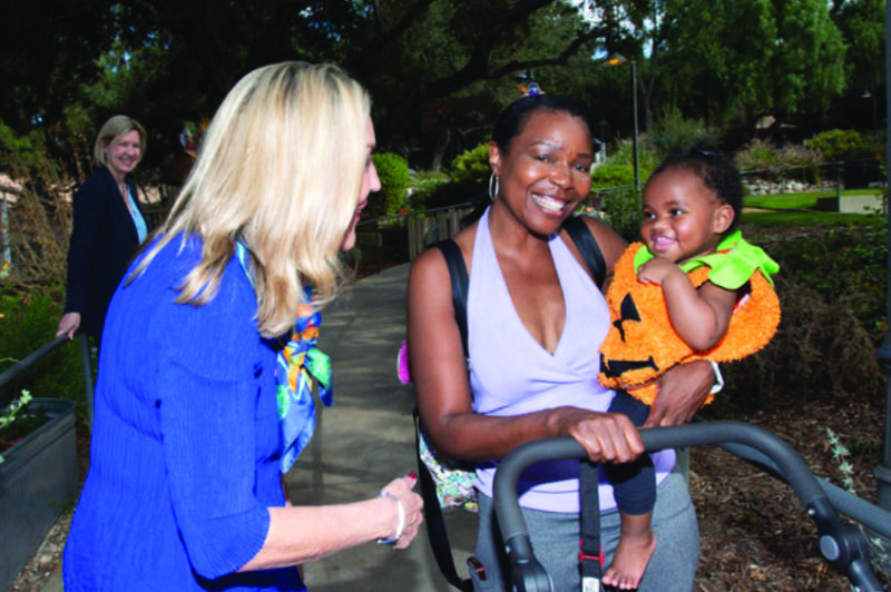 Supervisor Kathryn Barger shares a moment with a family attending a foster youth event at Kidspace Museum in Pasadena. (Photo credit: Michael Baker/Los Angeles County)