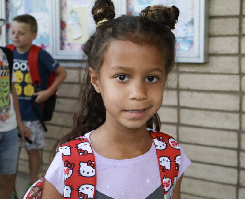 Juliette Tensen, 5, smiles for a photo while she waits in line on the first day of school at Highlands Elementary School in Saugus, Calif., Wednesday, Aug. 12, 2026. Kamryn Martell/The Signal