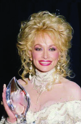 Dolly Parton at the People's Choice Awards in 1988. "Dolly Parton 1988" by Alejo Castillo is licensed under CC BY-SA 2.0. To view a copy of this license, visit https://creativecommons.org/licenses/by-sa/2.0/?ref=openverse.