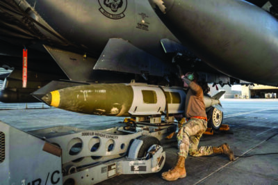 A U.S. Airman attaches a GBU-31 munitions system to an F-15E Strike Eagle in the U.S. Central Command area of responsibility, in an undisclosed location, on Dec. 18. U.S. Air Force via Getty Images