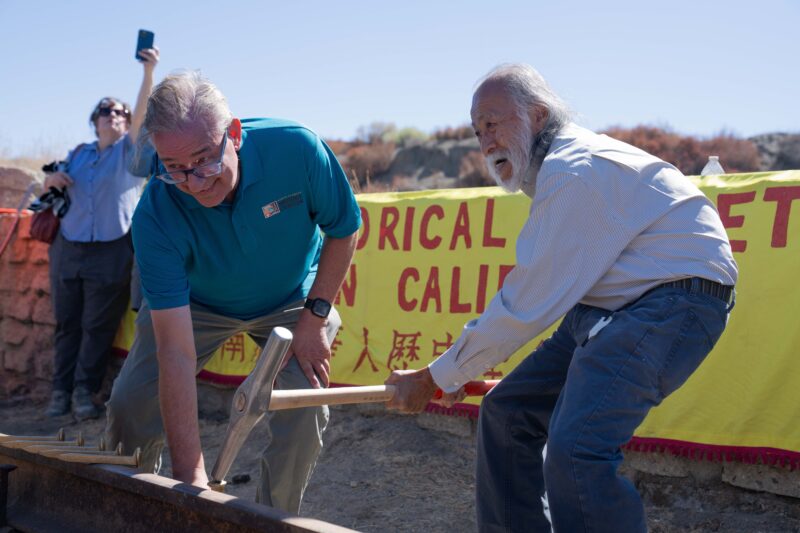 SCV Historical Society Allan Pollack (left) and Past President of the Chinese Historical Society of Southern California Eugene Moy reenact the Golden Spike during the Anniversary Celebration on Saturday, at Lang Station Road in Canyon Country Sept. 5, 2026. Katherine Quezada/The Signal