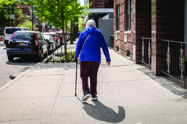 An elderly woman walks on a street in New York City on April 29, 2026. Photo by Samira Bouaou.