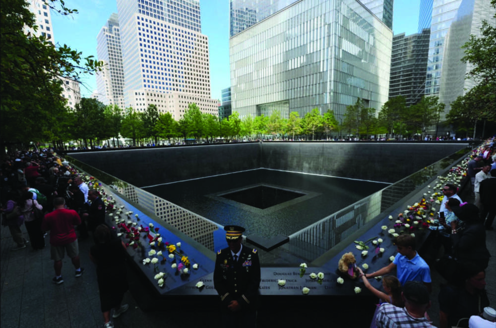Visitors gather at the reflecting pools on the 25th anniversary of the 9/11 terrorist attacks on the World Trade Center, at the National 9/11 Memorial & Museum in New York City on Sept. 11, 2026. Adam Gray - Pool/Getty Images