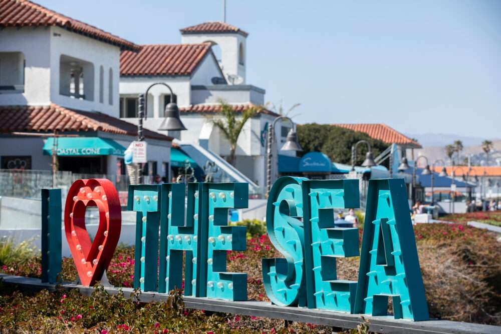 Experience a breezy, ocean-front reset at Ventura Harbor; just under an hour away. The harbor village features restaurants, ice cream shops, galleries, and waterfront paths that make it easy to spend an afternoon wandering without an agenda. ©Adobestock