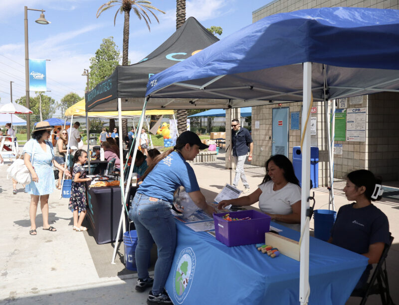 Vendor booths line up on the side of the pool at the Samuel Dixon Family Health Center's 23rd annual "Duck Dash" at the Santa Clarita Awuatic Center in Santa Clarita, Calif., Sunday, Sept. 20, 2026. Kamryn Martell/The Signal