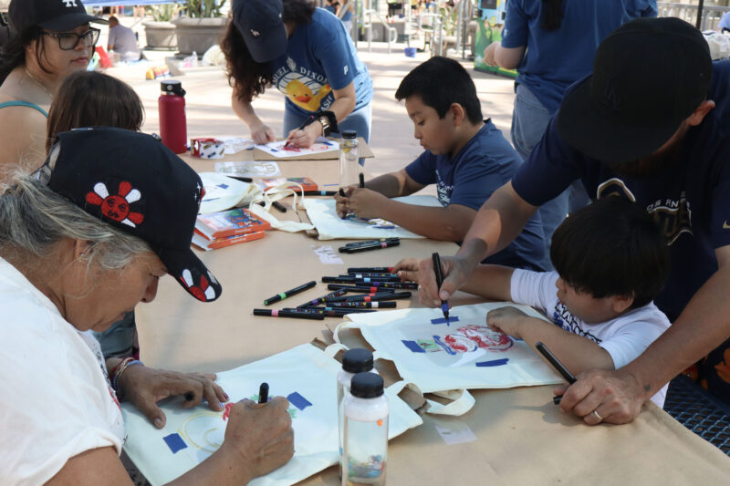 Attendees decorate tote bags at the Samuel Dixon Family Health Center's 23rd annual "Duck Dash"at the Santa Clarita Aquatic Center in Santa Clarita, Calif., Sunday, Sept. 20, 2026. Kamryn Martell/The Signal