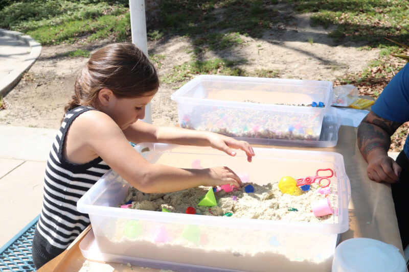 Selena Payne, 7, plays with a sand box at the Samuel Dixon Family Health Center's 23rd annual "Duck Dash" at the Santa Clarita Aquatic Center in Santa Clarita, Calif., Sunday, Sept. 20, 2026. Kamryn Martell/The Signal